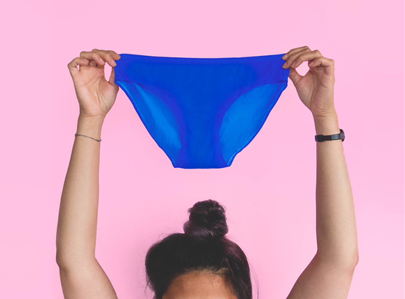 A Person Holding a White Panty with Period Stain · Free Stock Photo